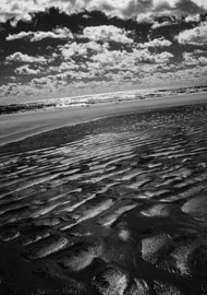 Black and white fine art print of the ocean after a tide. Infrared photography with digital Canon camera